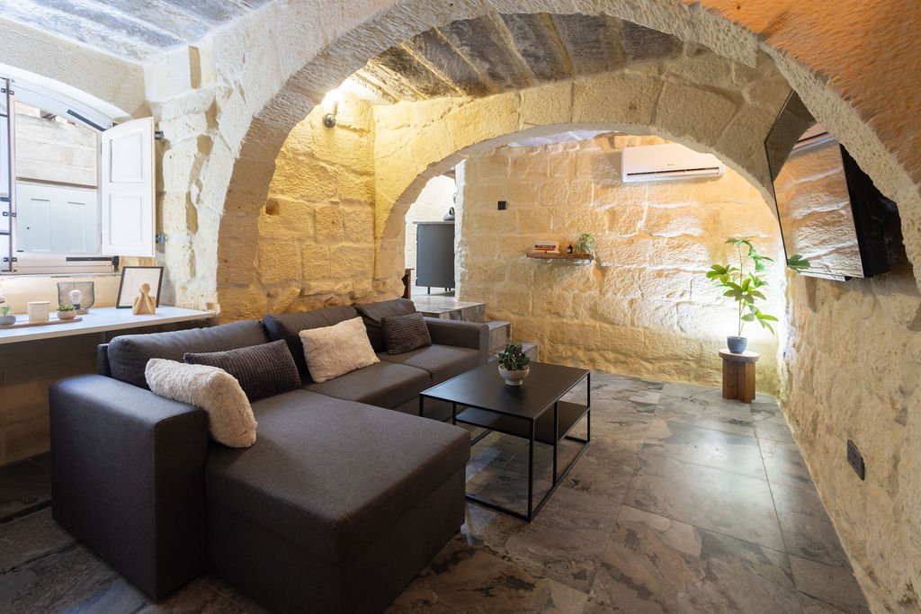 Traditional limestone living room with arched ceiling at The Retreat in Gozo