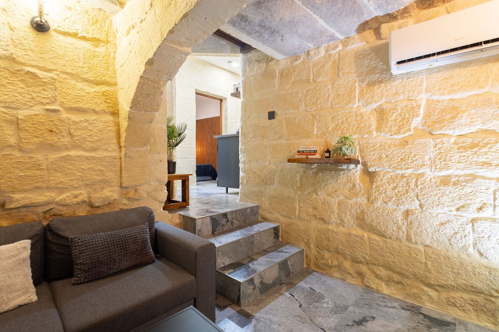 Traditional limestone interior with steps leading to the bedroom and kitchen